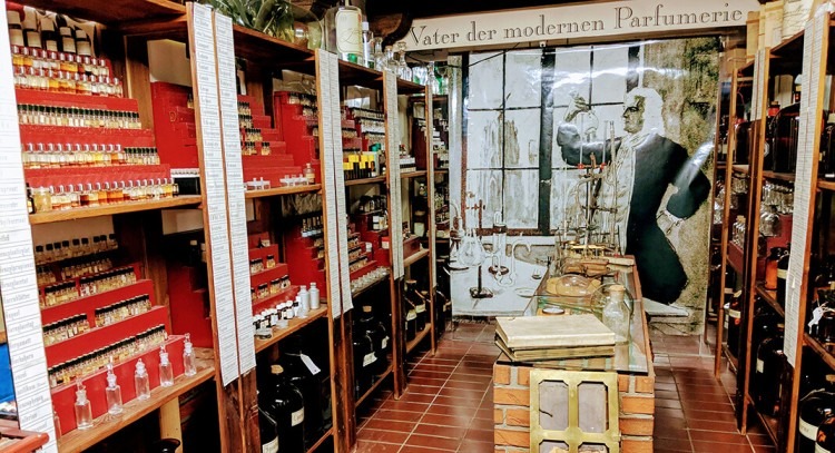 Interior of the Farina House with rows of perfume bottles and mirrors reflecting light
