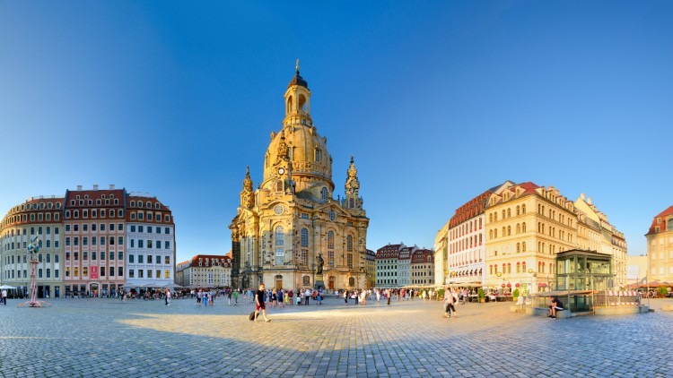 Frauenkirche in Dresden with blue sky and surrounding buildings