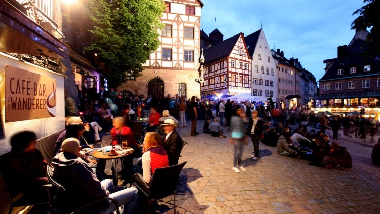 Traditional German beer festival with people and half-timbered houses in the background