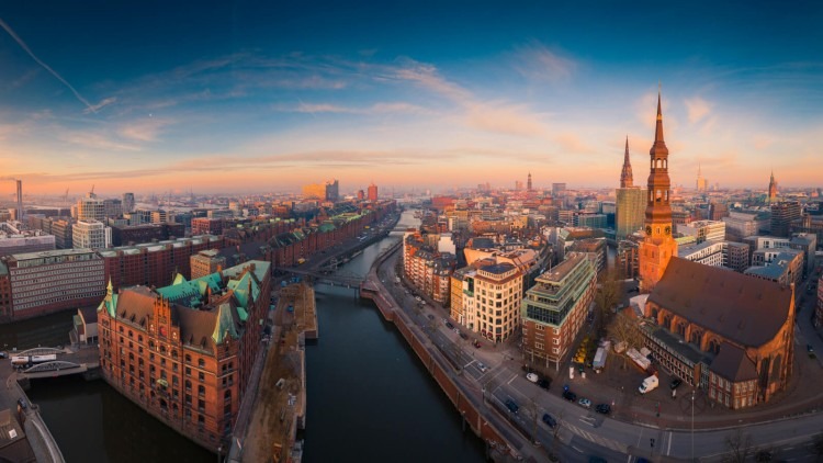 Aerial view of a German cityscape at sunset with river and buildings